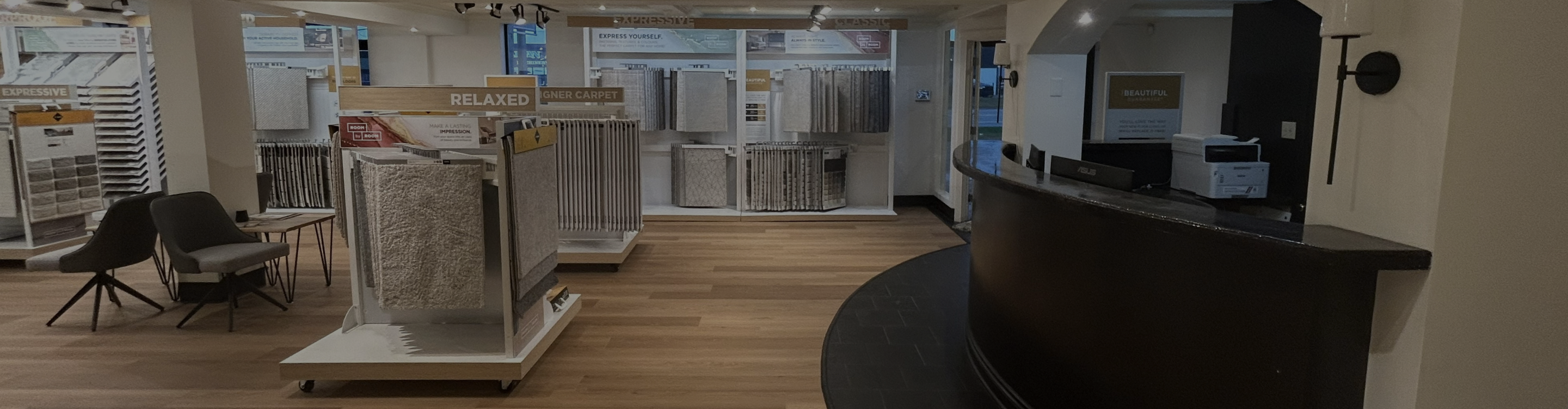 Absolute Floor & Home front desk area with carpet samples infront of it.