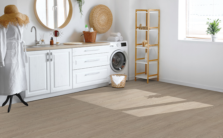 laundry room with brown luxury vinyl floors